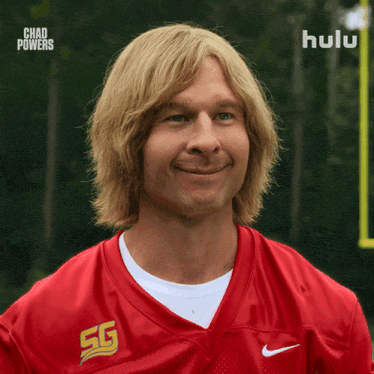 a man wearing a red nike jersey with sg on the front