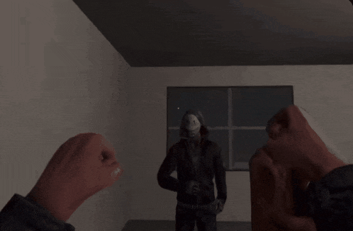 a man in a mask stands in a dark room