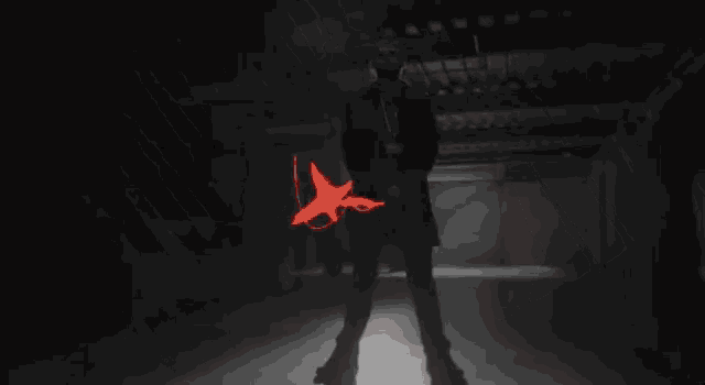 a red fist on a black background with a shadow of a person behind it