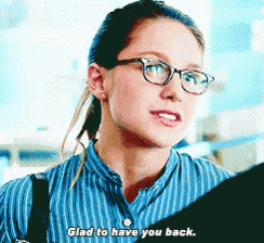 a woman wearing glasses and a striped shirt says glad to have you back