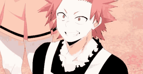 a man with red hair is wearing a black and white apron .