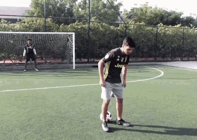 a soccer player wearing a jeep jersey kicks a ball