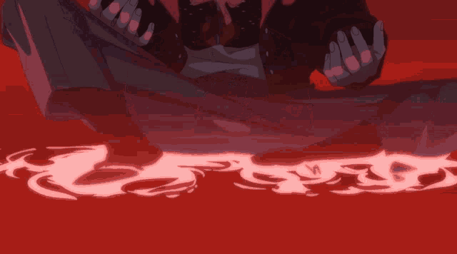 a person in a black jacket sits on the ground with their hands in the air