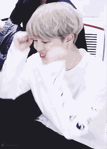 a person wearing a white sweater with the word army on the sleeve