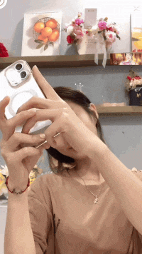 a woman is taking a picture of herself with her phone in a clear case