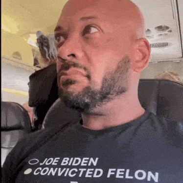 a man wearing a shirt that says joe biden convicted felon on it