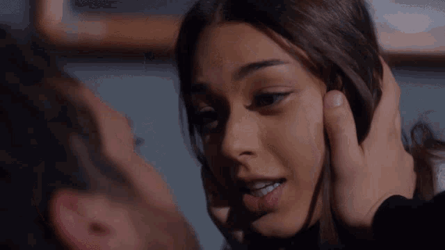 a man is touching the face of a woman