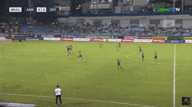 a soccer game is being played in a stadium sponsored by cosmote