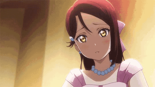 a close up of a girl in a purple dress with a necklace .