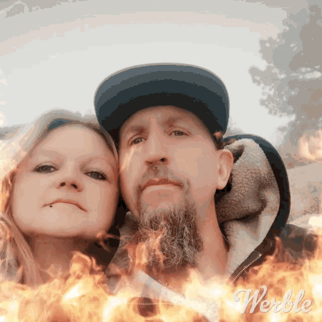 a man and a woman are standing next to each other with fire behind them and the word weddle visible