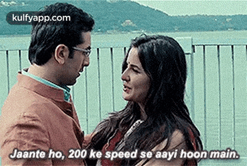 a man and a woman are standing next to each other and the woman is talking to the man in a movie .