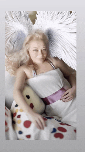 a woman in a white dress with angel wings