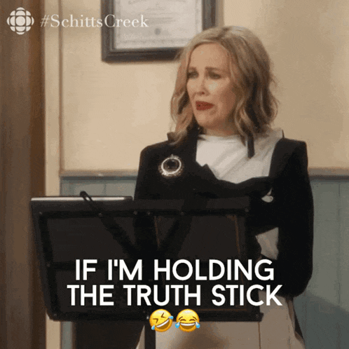 a woman stands at a podium with the words if i 'm holding the truth stick above her