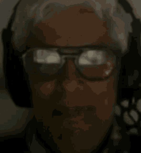 a close up of a man wearing headphones and sunglasses