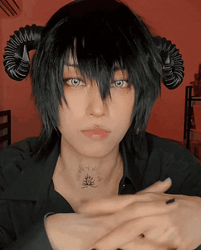 a woman with horns on her head has a tattoo on her neck