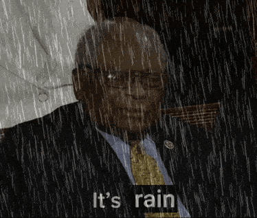 a man in a suit and tie stands in the rain with the words it 's rain below him