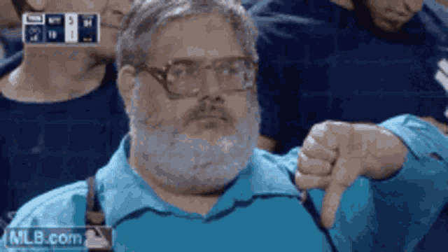 a man with a beard and suspenders giving a thumbs down