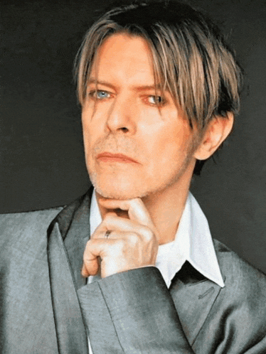 a close up of a man 's face with a hand on his chin