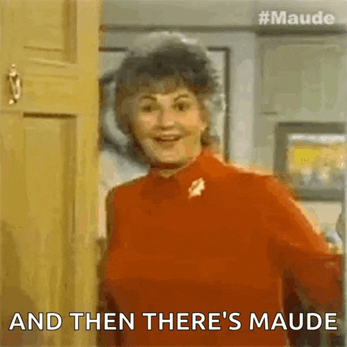 a woman is standing in front of a door with the words `` and then there 's maude '' written on it .