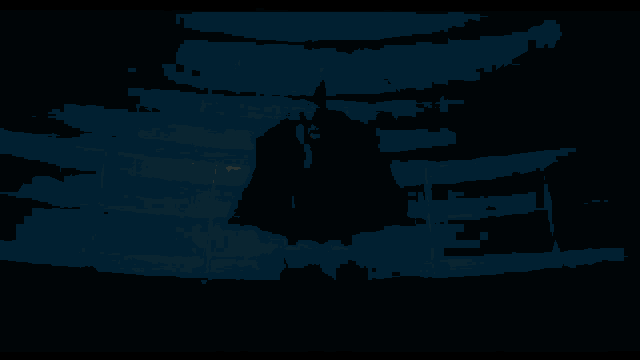 a man is standing in a dark room with two lights on the wall