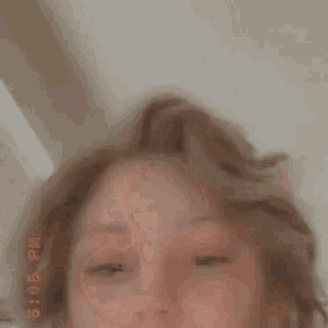 a close up of a person 's face with a blurry background .