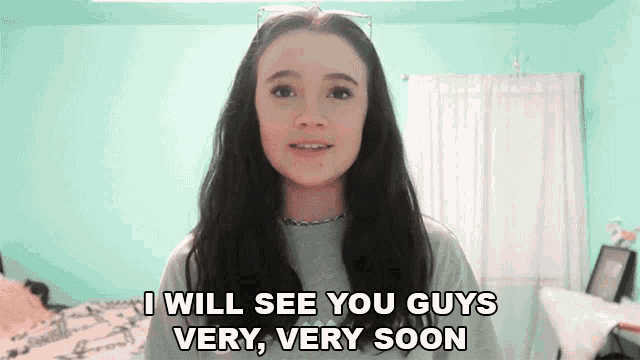 a girl in a bedroom says i will see you guys very very soon