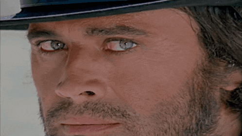 a close up of a man wearing a hat