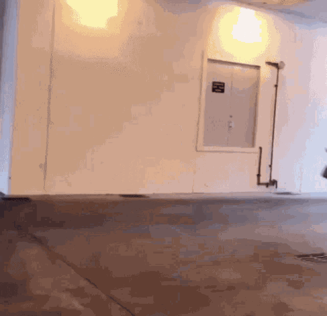 a white wall with a sign on it that says ' emergency exit '