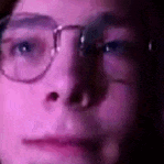 a close up of a person 's face with glasses .