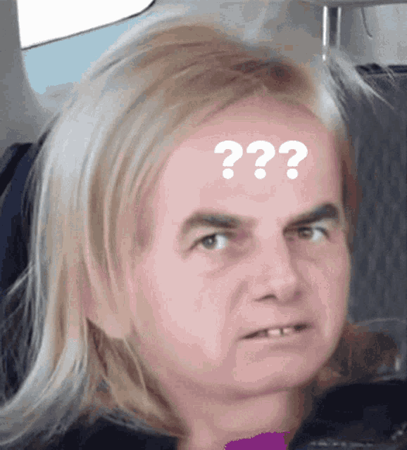 a woman with long blonde hair has a question mark on her forehead