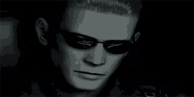 a close up of a man wearing sunglasses in a black and white photo .
