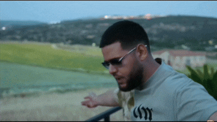 a man wearing sunglasses and a t-shirt that says ' ss ' on it