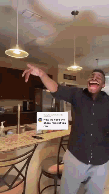 a man is making a funny face in a kitchen