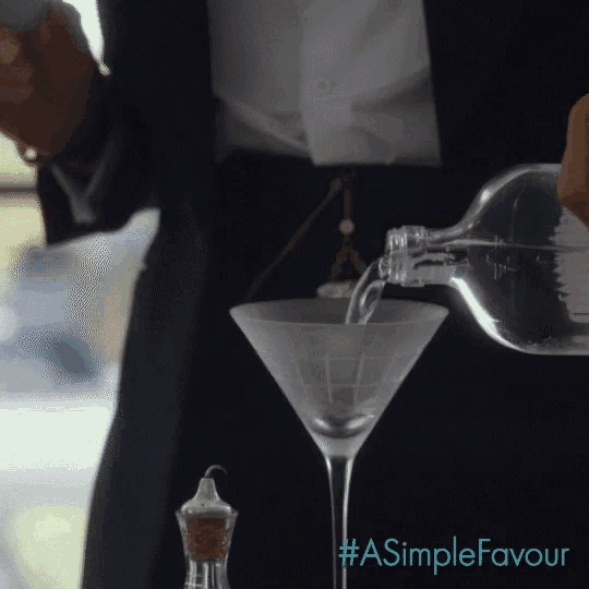 a man pouring liquid into a martini glass with a simple favour written on the bottom