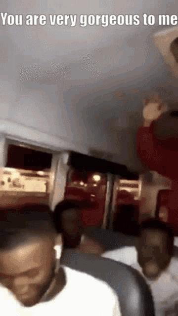 a group of people are sitting on a bus and the caption says you are very gorgeous to me