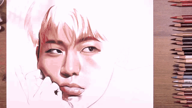 a person is drawing a man 's face with a pencil
