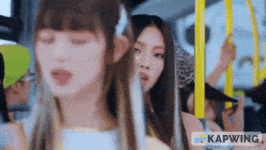 a group of girls are riding a bus and the word kapwing is on the bottom of the screen