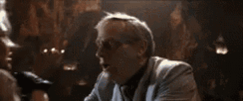 a man is standing next to a woman in a dark room .