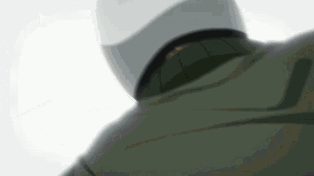 a close up of a person 's back with a white helmet on .