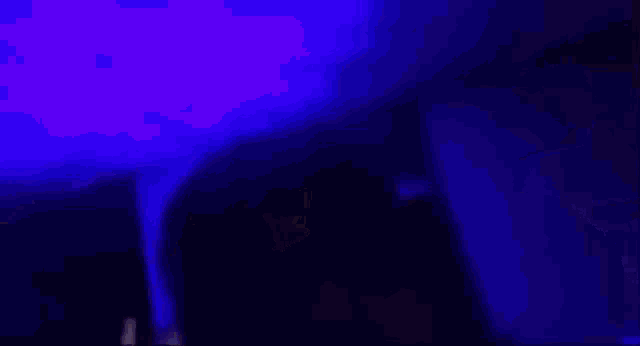 a close up of a woman 's face with blue lights behind her .