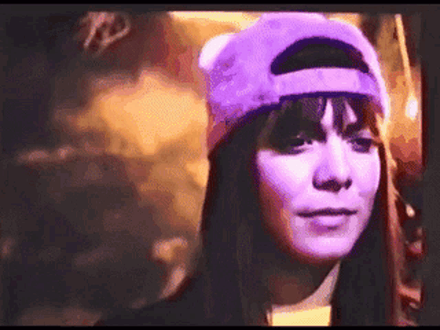 a woman wearing a purple hat and a purple shirt