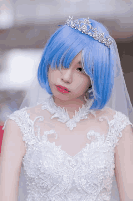 a woman with blue hair wearing a white dress and tiara