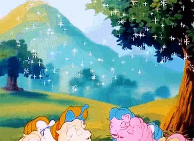 a cartoon of two ponies in a field with a tree and mountains in the background