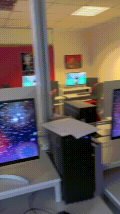 a blurred image of a room with a few computer monitors