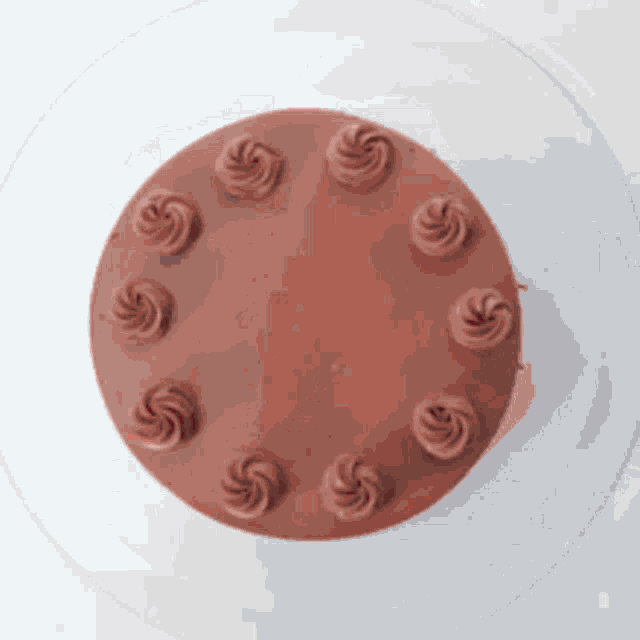 a chocolate cake with frosting swirls on it
