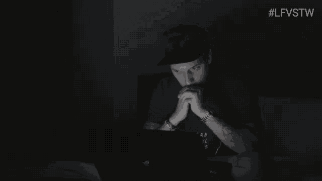a man is sitting in front of a laptop with the words hi sweetheart on the screen
