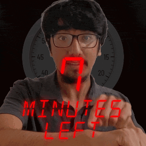 a man wearing glasses is pointing at the words " minutes left " on his wrist