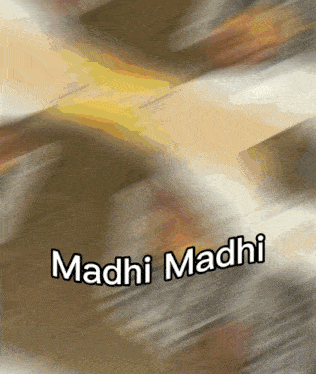 a blurred image with the words madhi madhi written on it