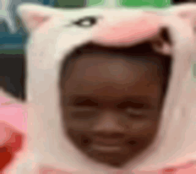 a close up of a child wearing a unicorn costume