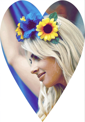 a woman wearing a heart shaped headband with blue and yellow flowers in her hair